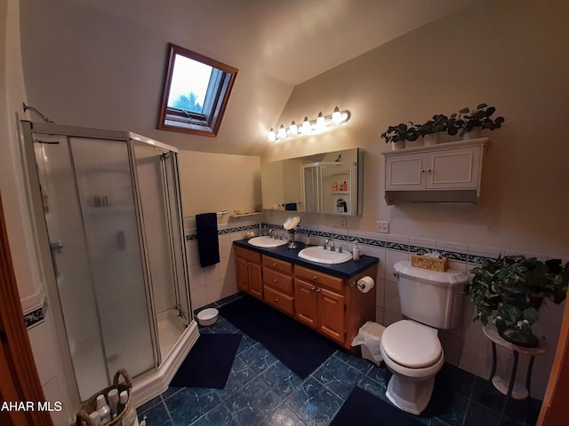 bathroom with vanity, lofted ceiling with skylight, tile patterned flooring, tile walls, and an enclosed shower