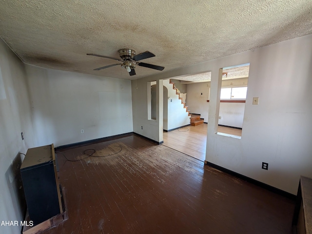 unfurnished living room featuring wood-type flooring, a textured ceiling, and ceiling fan