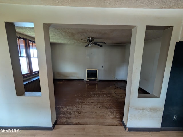 unfurnished room with ceiling fan, hardwood / wood-style floors, and a textured ceiling