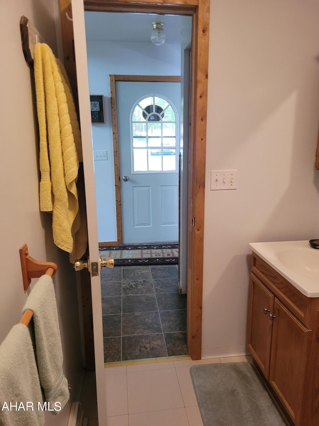 interior space with tile patterned flooring and a sink