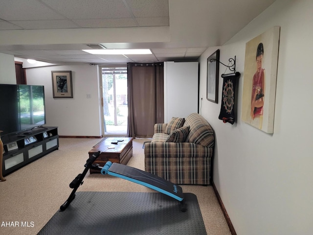 exercise area featuring carpet floors, a paneled ceiling, visible vents, and baseboards