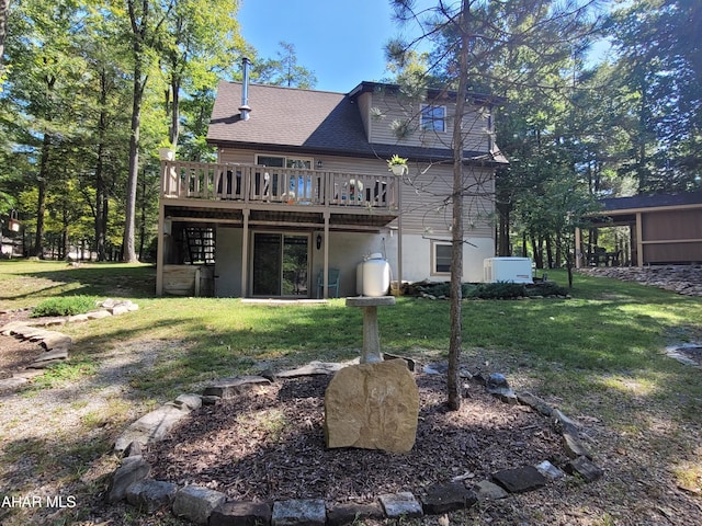 back of house with a yard and a deck