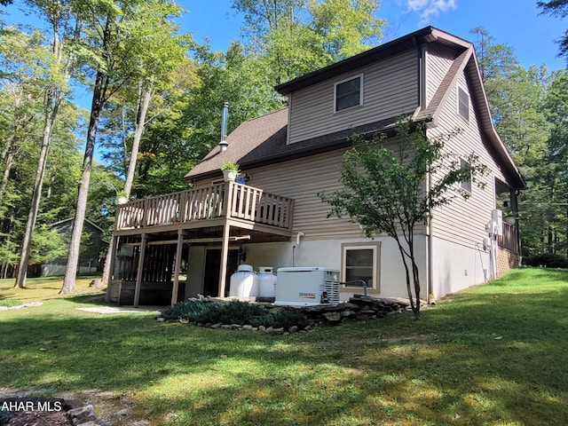 back of property featuring a lawn and a wooden deck