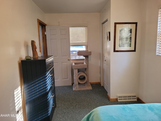 bedroom featuring dark colored carpet, a closet, visible vents, and baseboards