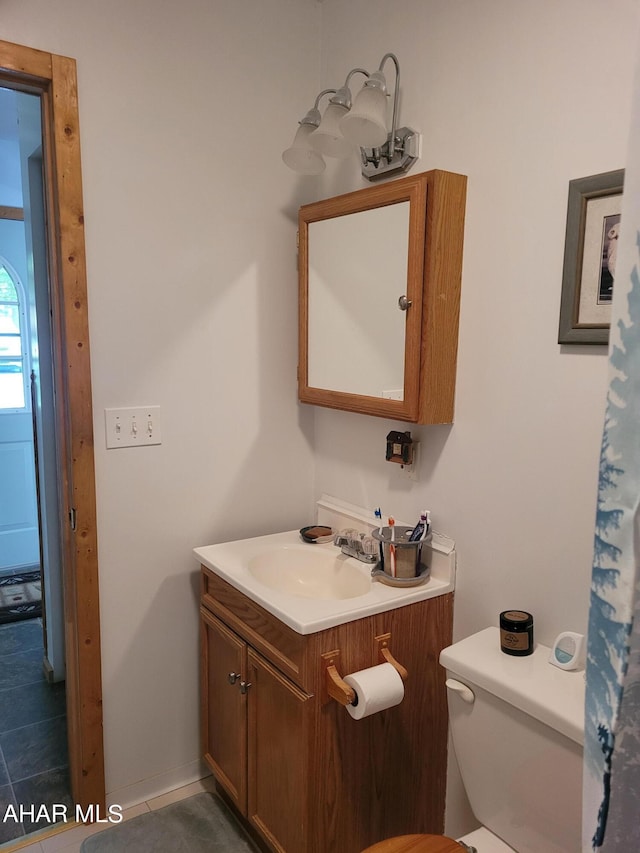 bathroom featuring vanity, toilet, and tile patterned floors