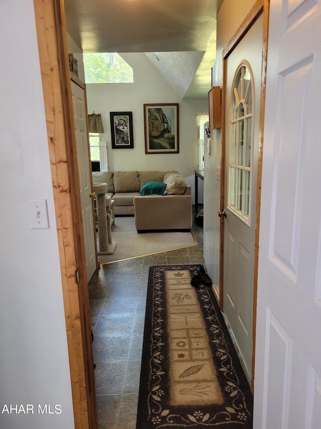 hallway featuring vaulted ceiling