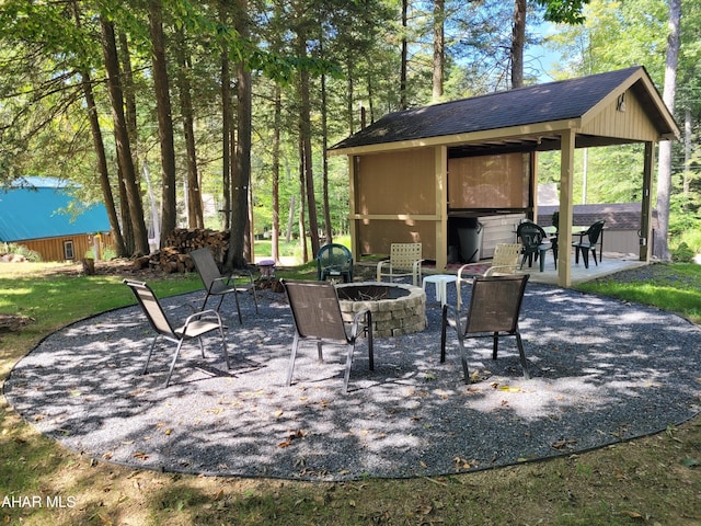 view of patio / terrace featuring a shed and a fire pit