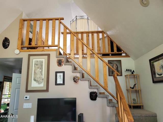 stairs featuring lofted ceiling