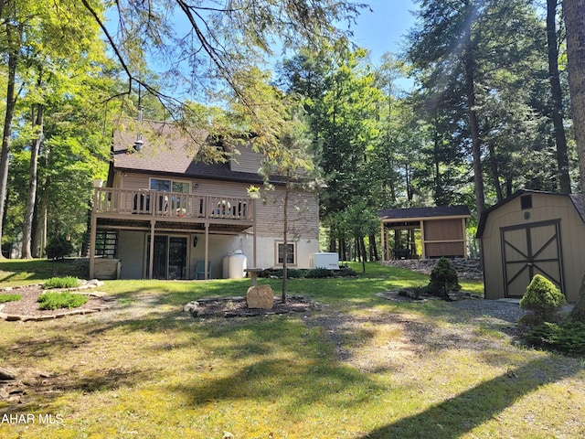 view of yard with a storage shed, a wooden deck, and an outdoor structure