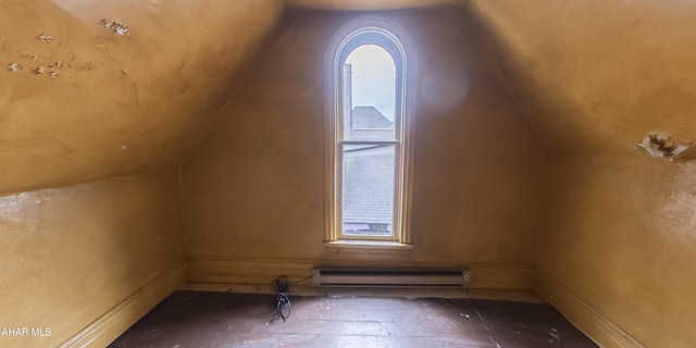 additional living space with vaulted ceiling and a baseboard radiator