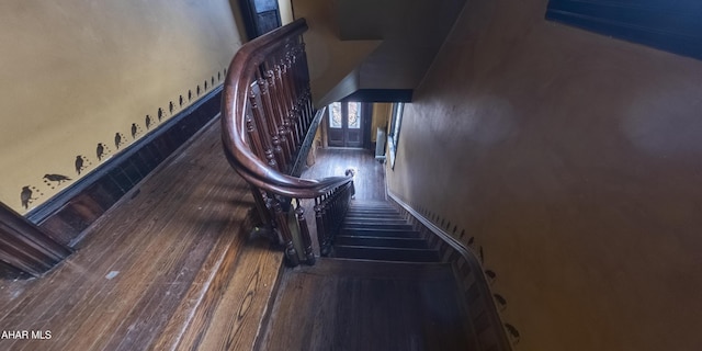 staircase featuring wood-type flooring