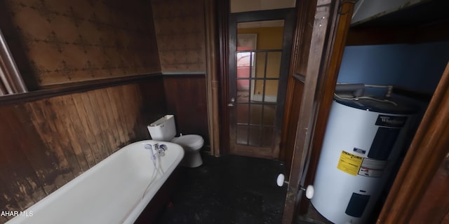 bathroom featuring electric water heater, a bath, wood walls, and toilet