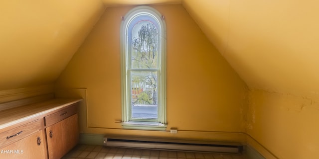 additional living space with lofted ceiling and baseboard heating