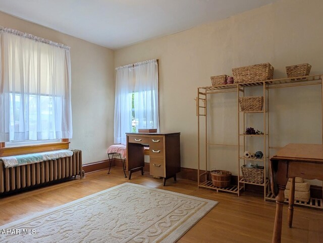 902 Main St, Saxton, PA 16678 - office area with radiator heating unit and wood finished floors