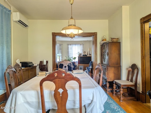 902 Main St, Saxton, PA 16678 - dining area with a wall unit AC and wood finished floors