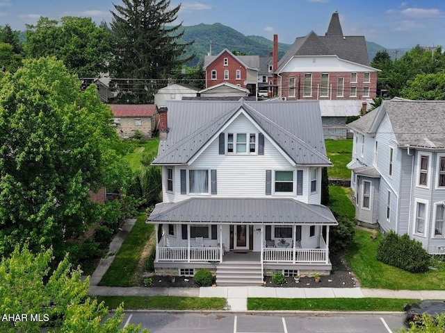 902 Main St, Saxton, PA 16678 - view of front facade featuring covered porch, uncovered parking, metal roof, and a mountain view