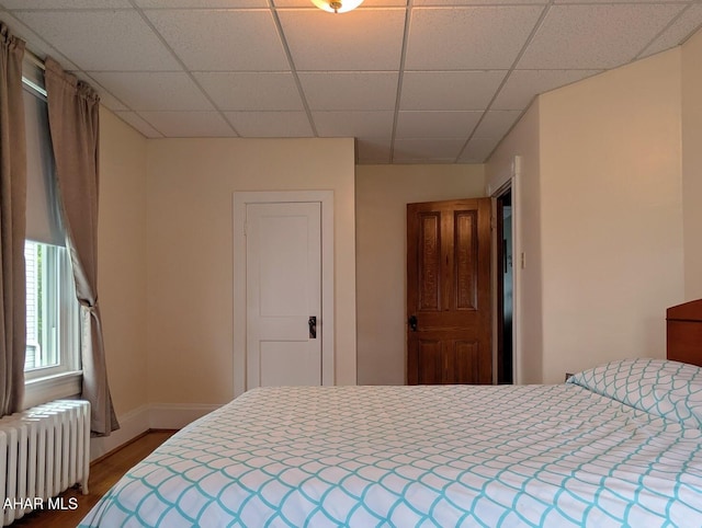902 Main St, Saxton, PA 16678 - bedroom with radiator heating unit, wood finished floors, a drop ceiling, and baseboards