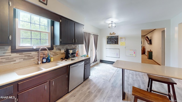 829 Ashcroft Ave, Cresson, PA 16630 - kitchen featuring stainless steel dishwasher, a sink, light wood-style floors, and backsplash