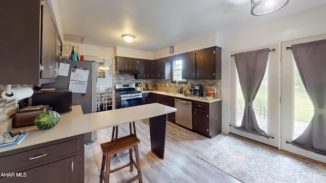 829 Ashcroft Ave, Cresson, PA 16630 - kitchen with appliances with stainless steel finishes, dark brown cabinetry, decorative backsplash, and light countertops
