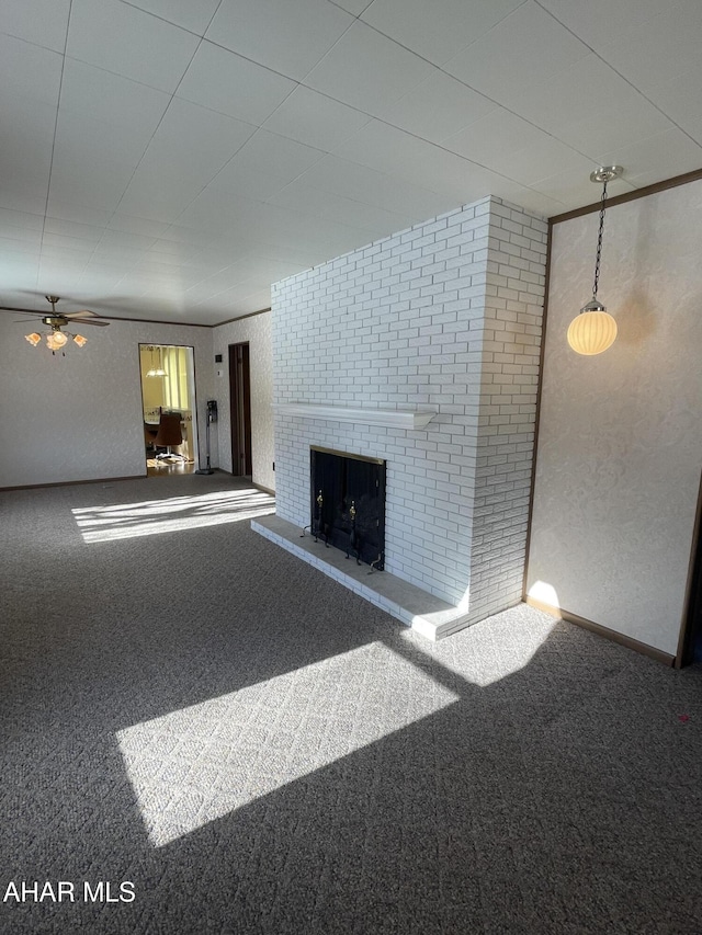 unfurnished living room featuring carpet floors and a brick fireplace