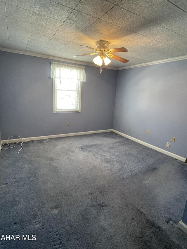 carpeted spare room with crown molding and ceiling fan