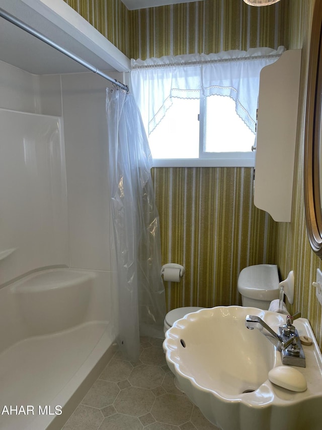 bathroom with sink, tile patterned floors, and walk in shower