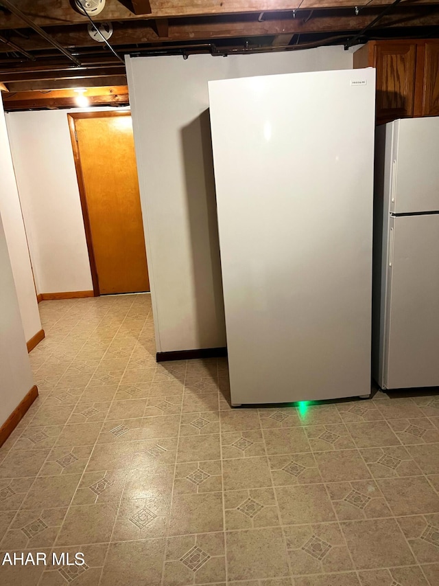 basement featuring white fridge