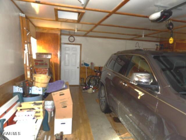 garage with a garage door opener and a carport