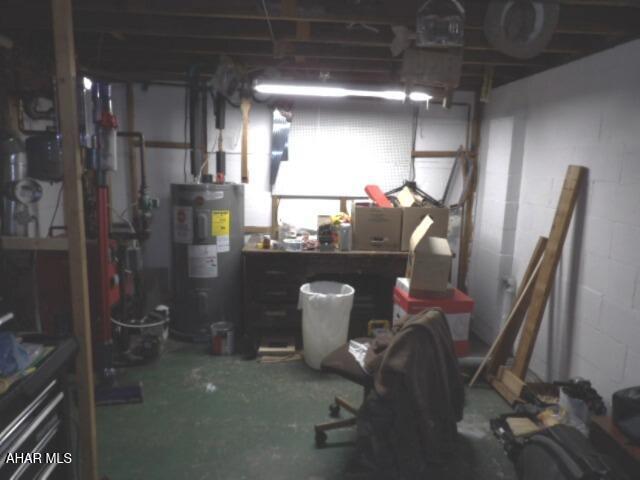 basement featuring water heater and a workshop area