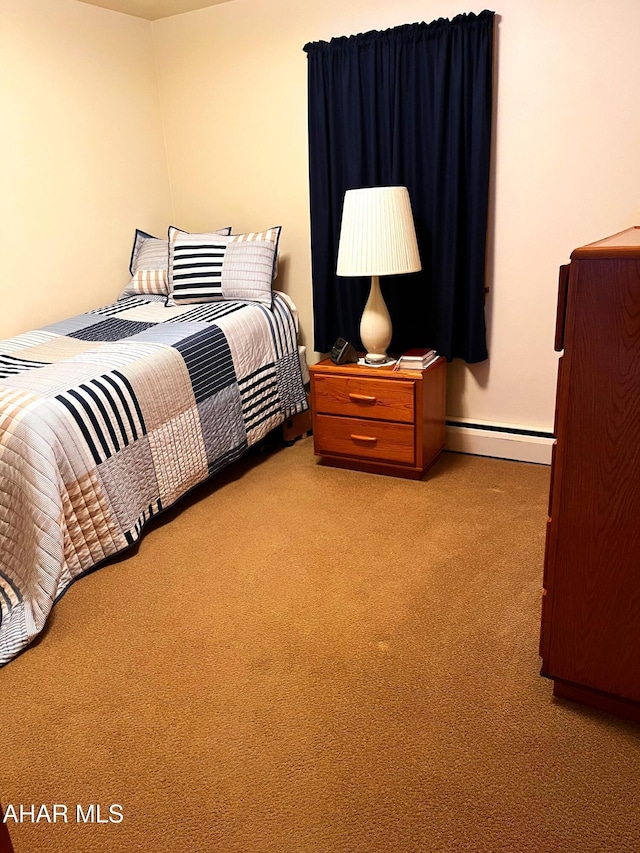 carpeted bedroom featuring baseboard heating