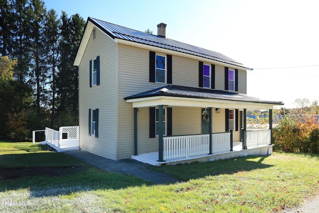 farmhouse inspired home with covered porch and a front yard