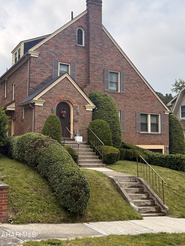 414 27th Ave, Altoona, PA 16601 - view of front of property featuring brick siding, a front yard, and a chimney