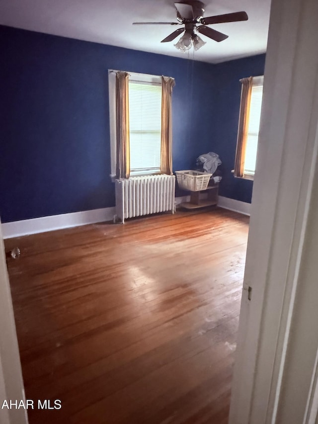 414 27th Ave, Altoona, PA 16601 - spare room with radiator, wood finished floors, a ceiling fan, and baseboards