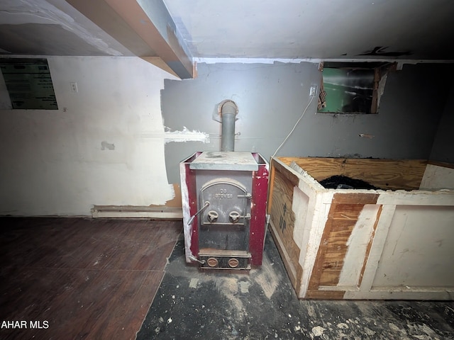 interior details featuring wood-type flooring and a wood stove