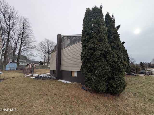 view of side of home with a lawn