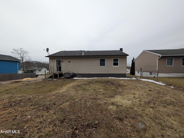 rear view of house with a yard