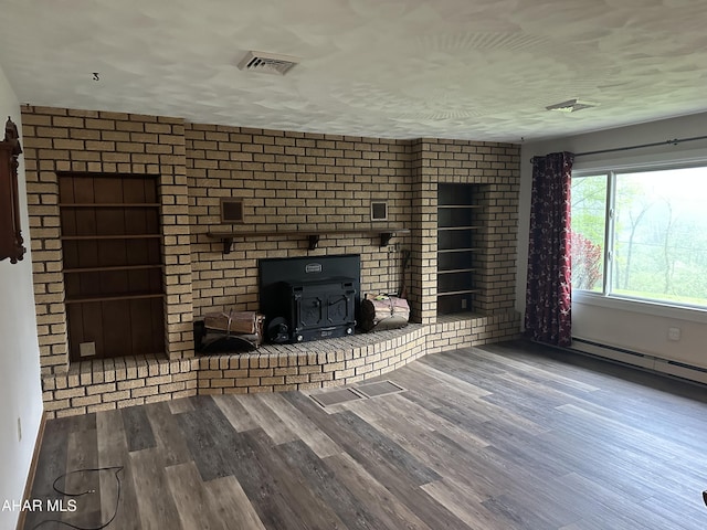 159 Hollidaysburg Sportsman Rd, Hollidaysburg, PA 16648 - unfurnished living room featuring wood finished floors, a wood stove, and a baseboard radiator