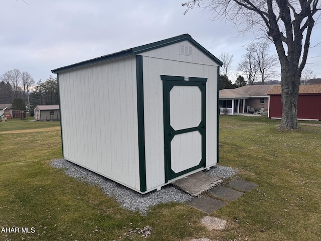 view of outbuilding featuring a lawn