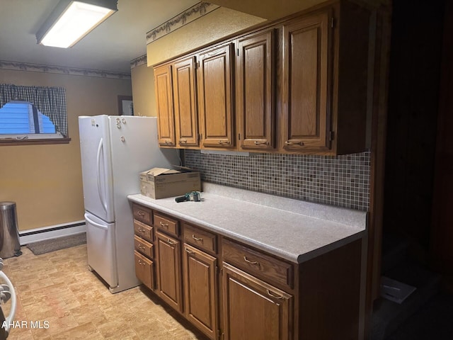 kitchen featuring decorative backsplash, white refrigerator, and a baseboard radiator