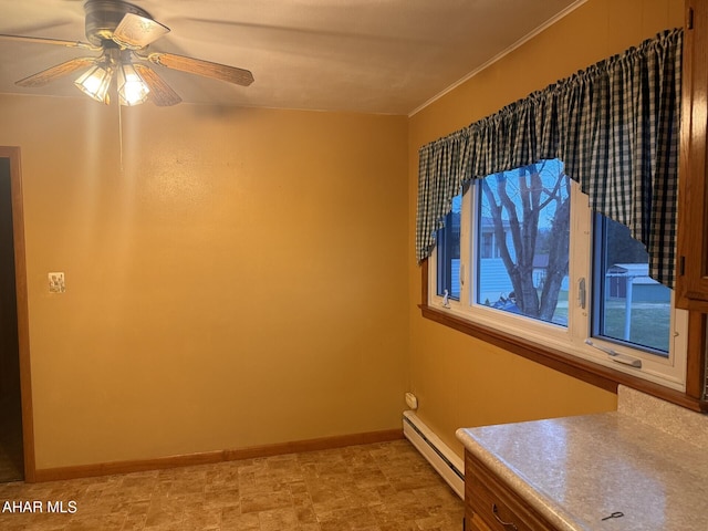 spare room with ceiling fan and a baseboard heating unit