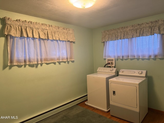 washroom with washer and dryer, dark wood-type flooring, a baseboard radiator, and a textured ceiling