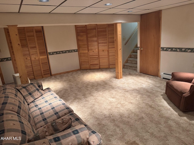 living room with a paneled ceiling, carpet, and a baseboard radiator