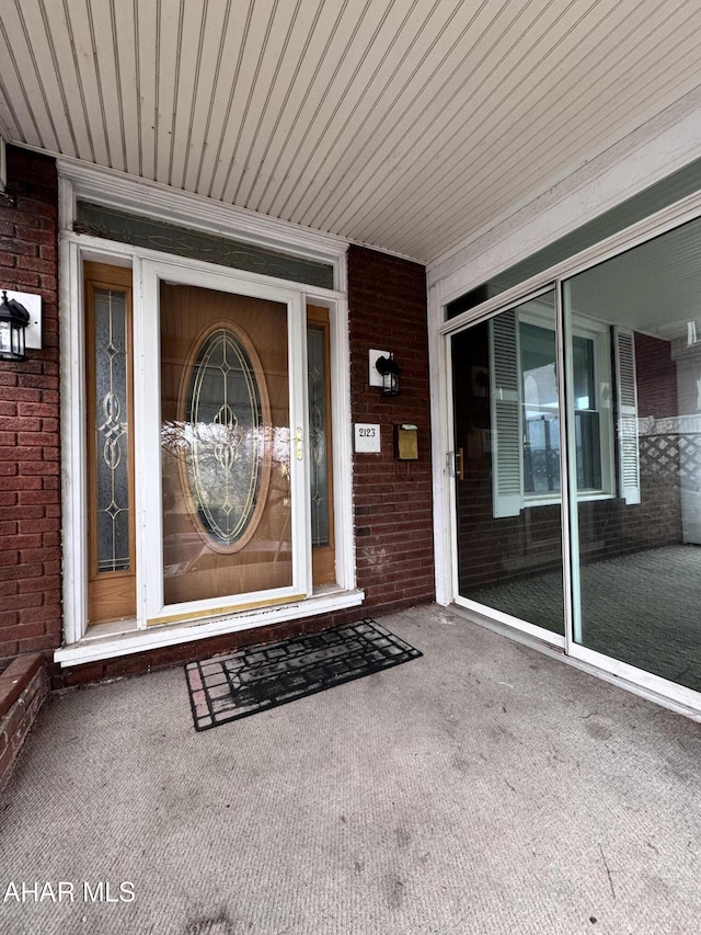2123 2nd Ave, Altoona, PA 16602 - view of exterior entry featuring brick siding and a porch