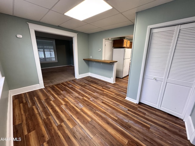 2123 2nd Ave, Altoona, PA 16602 - unfurnished dining area featuring a paneled ceiling, baseboards, and dark wood-type flooring