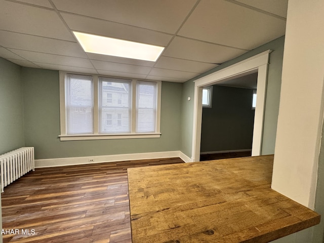 2123 2nd Ave, Altoona, PA 16602 - spare room with radiator heating unit, baseboards, a paneled ceiling, and wood finished floors