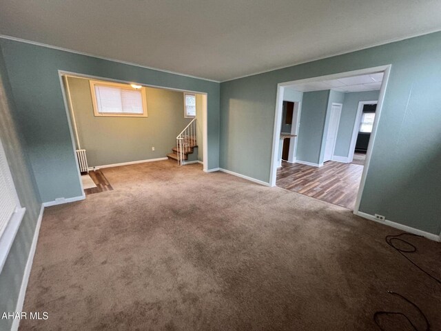 2123 2nd Ave, Altoona, PA 16602 - carpeted spare room with ornamental molding, baseboards, radiator heating unit, and stairs