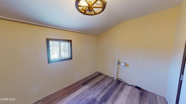 clothes washing area with wood finished floors