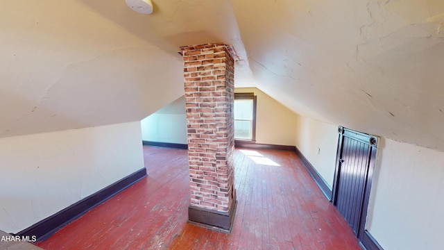 bonus room with baseboards, lofted ceiling, and hardwood / wood-style flooring