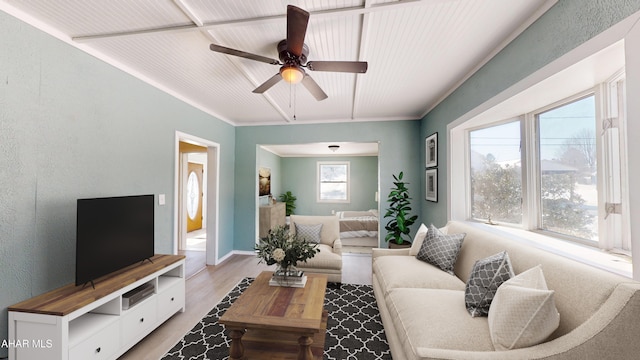 living room featuring ceiling fan, wood finished floors, and a textured wall