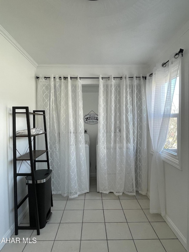 bathroom featuring baseboards, ornamental molding, and tile patterned flooring